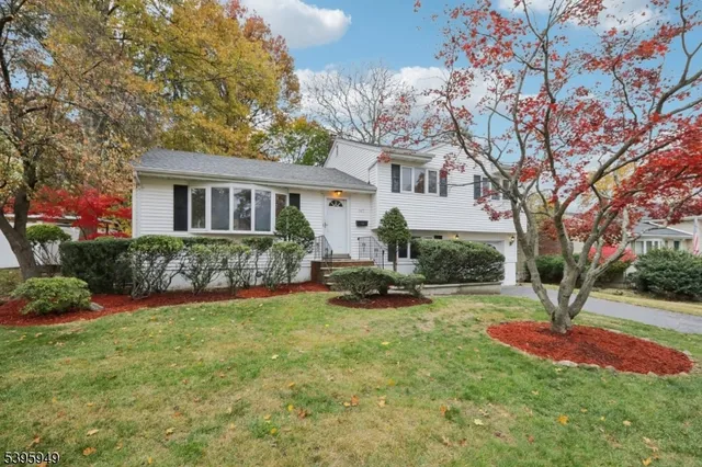 a front view of a house with a yard and porch