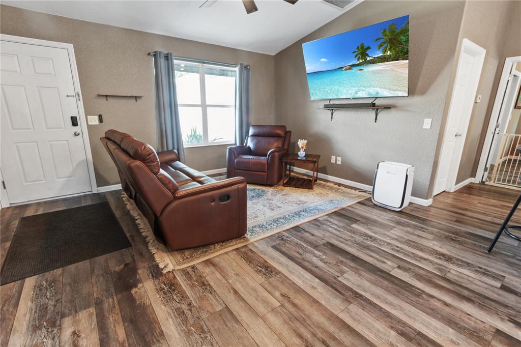6312 Central Avenue Coleman, FL 34785 - Photo 16 of 25 a living room with furniture rug and wooden floor