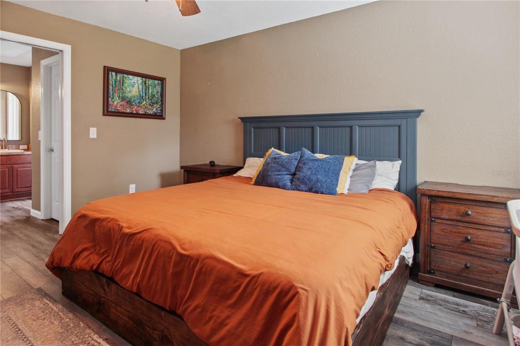 6312 Central Avenue Coleman, FL 34785 - Photo 20 of 25 a bedroom with a bed and wooden floor