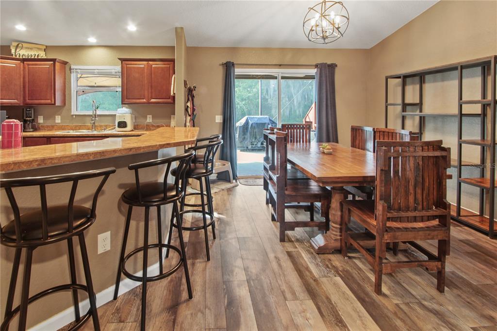 6312 Central Avenue Coleman, FL 34785 - Photo 3 of 25 a view of a dining room with furniture and wooden floor