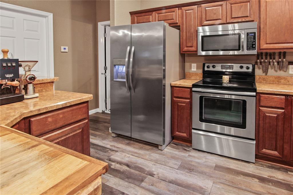 6312 Central Avenue Coleman, FL 34785 - Photo 5 of 25 a kitchen with a stove a microwave and a counter top space