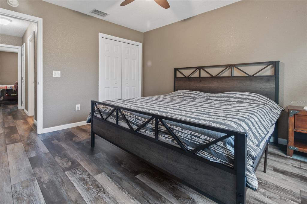 6312 Central Avenue Coleman, FL 34785 - Photo 9 of 25 a bed sitting in a bedroom next to a bathroom