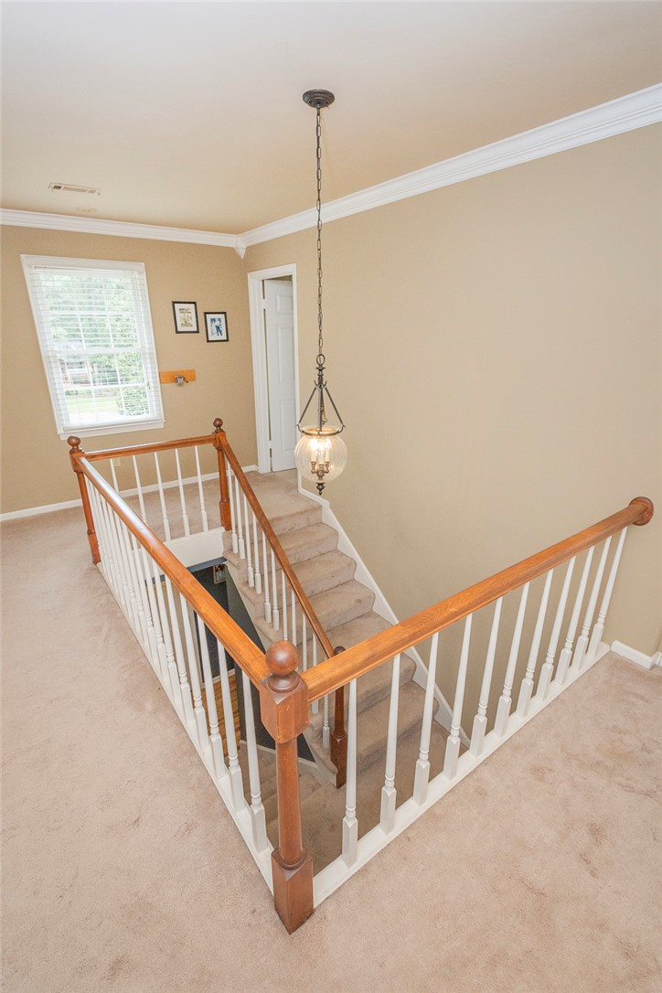 203 Oak Hollow Pendleton, SC 29670 - Photo 30 of 50 Elegant staircase with a classic banister and a stylish chandelier creates a refined transition between levels.