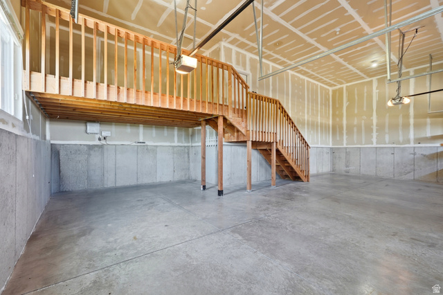 338 Windy Rdg Drive Smithfield, UT 84335 - Photo 53 of 63 Spacious garage interior featuring concrete flooring and a wood staircase leading to an elevated storage area