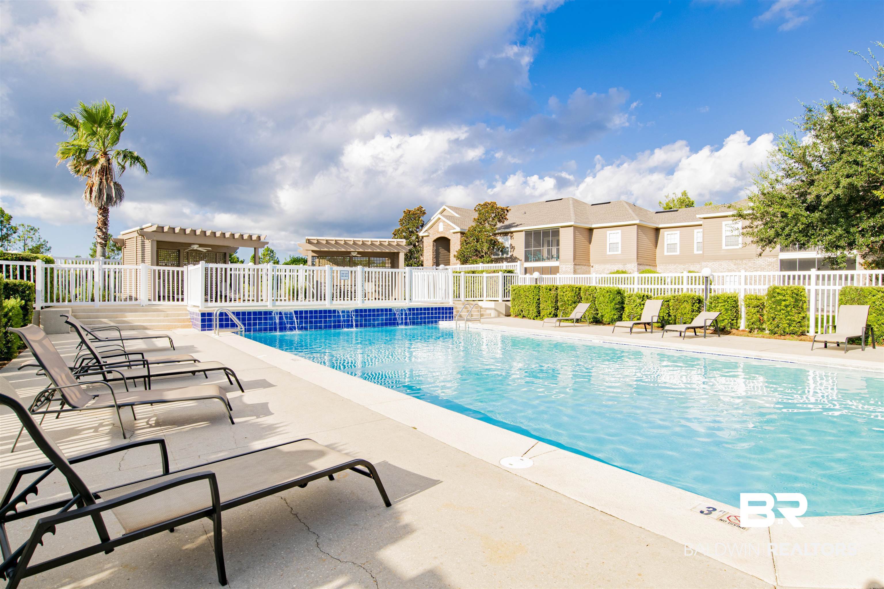 450 Park Avenue, Unit 202 Foley, AL 36535 - Photo 17 of 18 Community pool featuring a patio area and a residential view