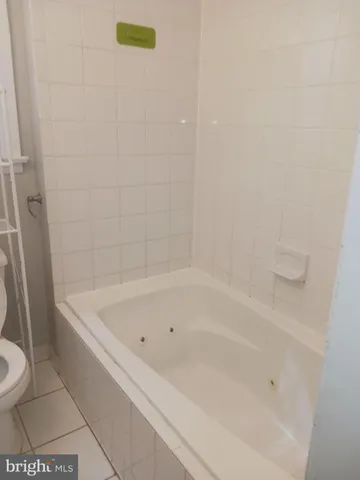 a bath tub sitting next to a white toilet