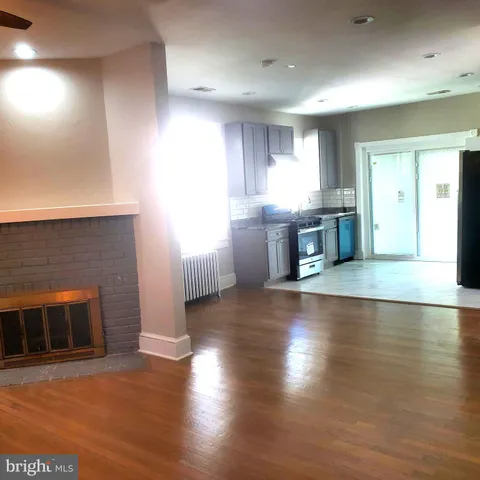 a view of a kitchen with a sink and a fireplace