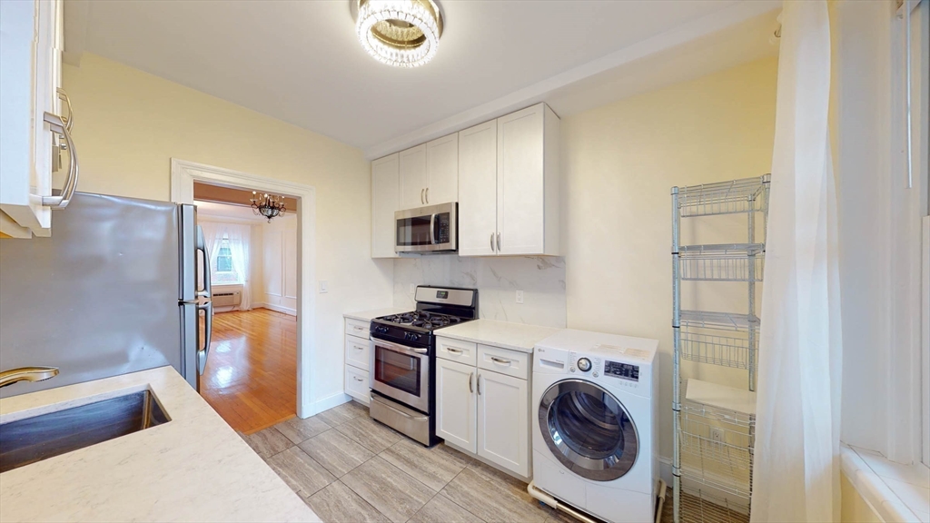 311 Tappan Street, Unit 3 Brookline, MA 02445 - Photo 15 of 35 a utility room with sink dryer and washer