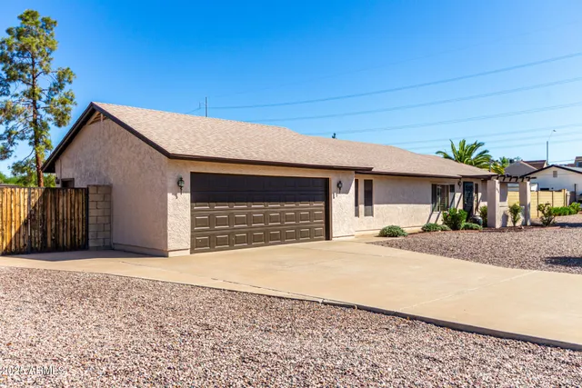 a front view of a house with a yard and a garage
