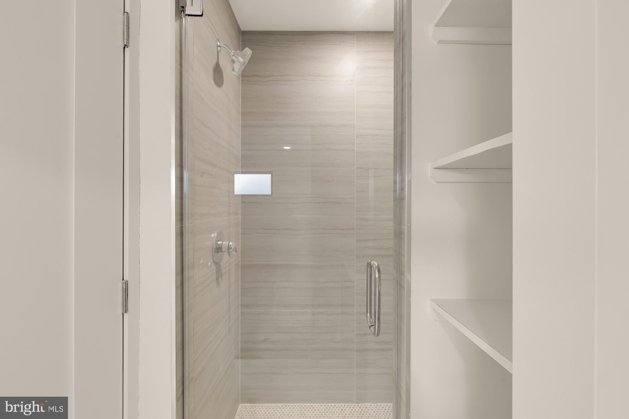 641 Quebec Place Northwest, Unit 1 Washington, DC 20010 - Photo 34 of 37 a bathroom with a glass shower door