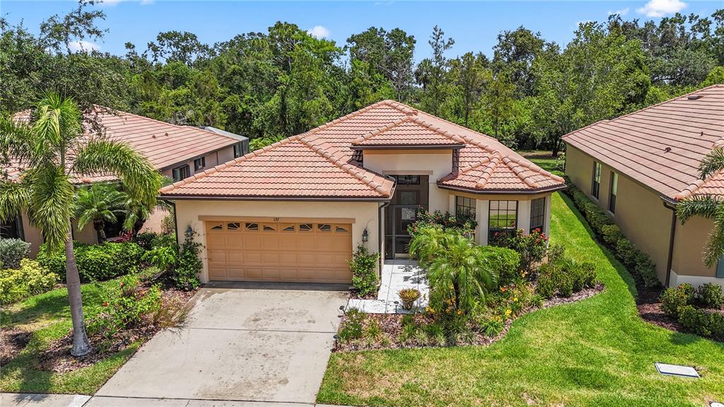 a front view of a house with a yard and garage