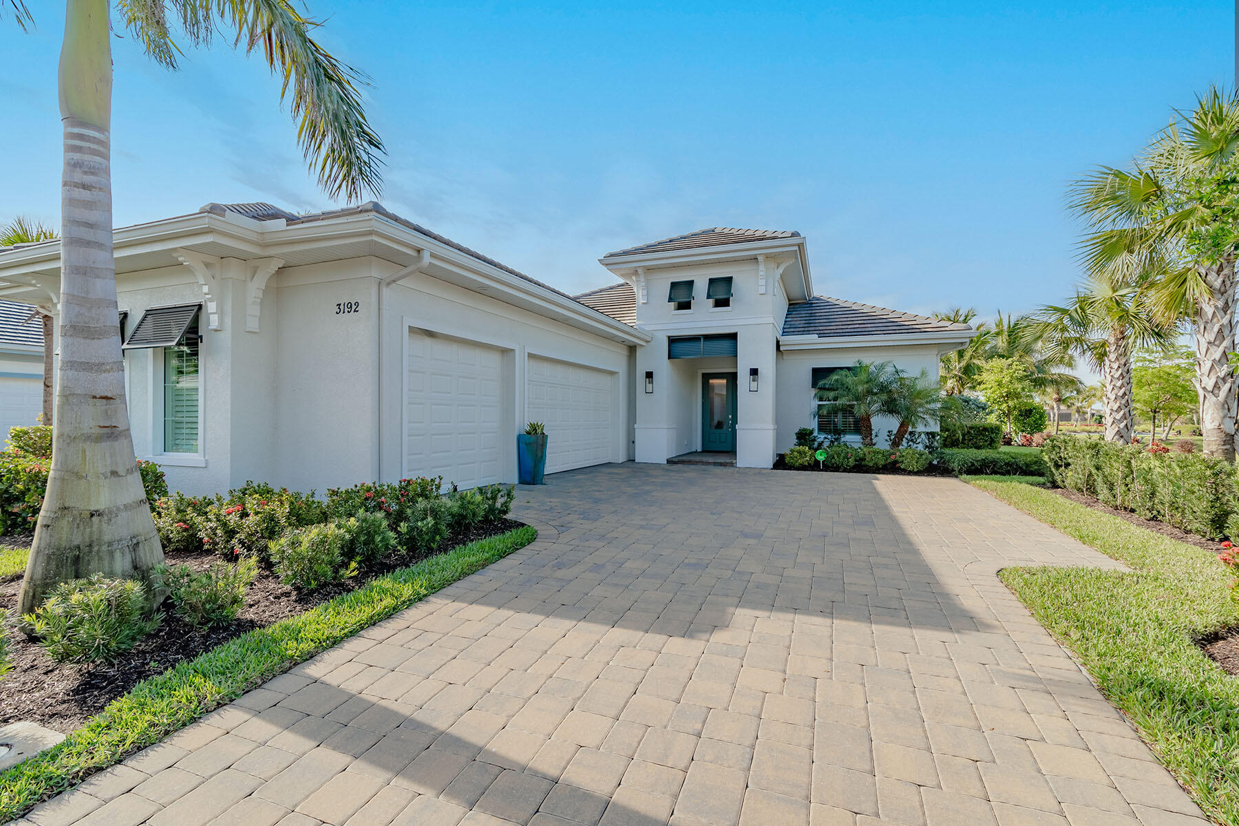 a view of a white house with a yard