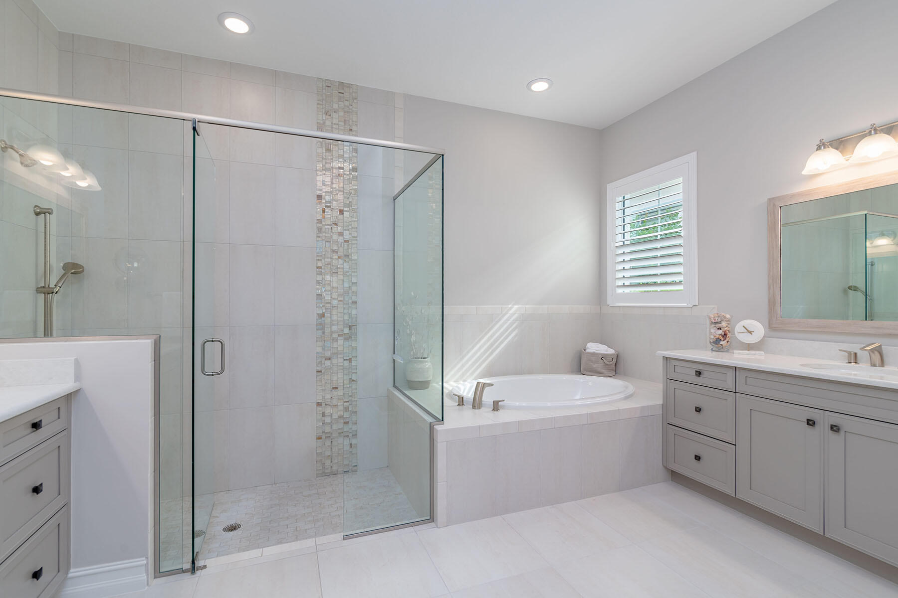3192 Capistrano Lane Naples, FL 34114 - Photo 12 of 38 a bathroom with a tub a sink shower and mirror