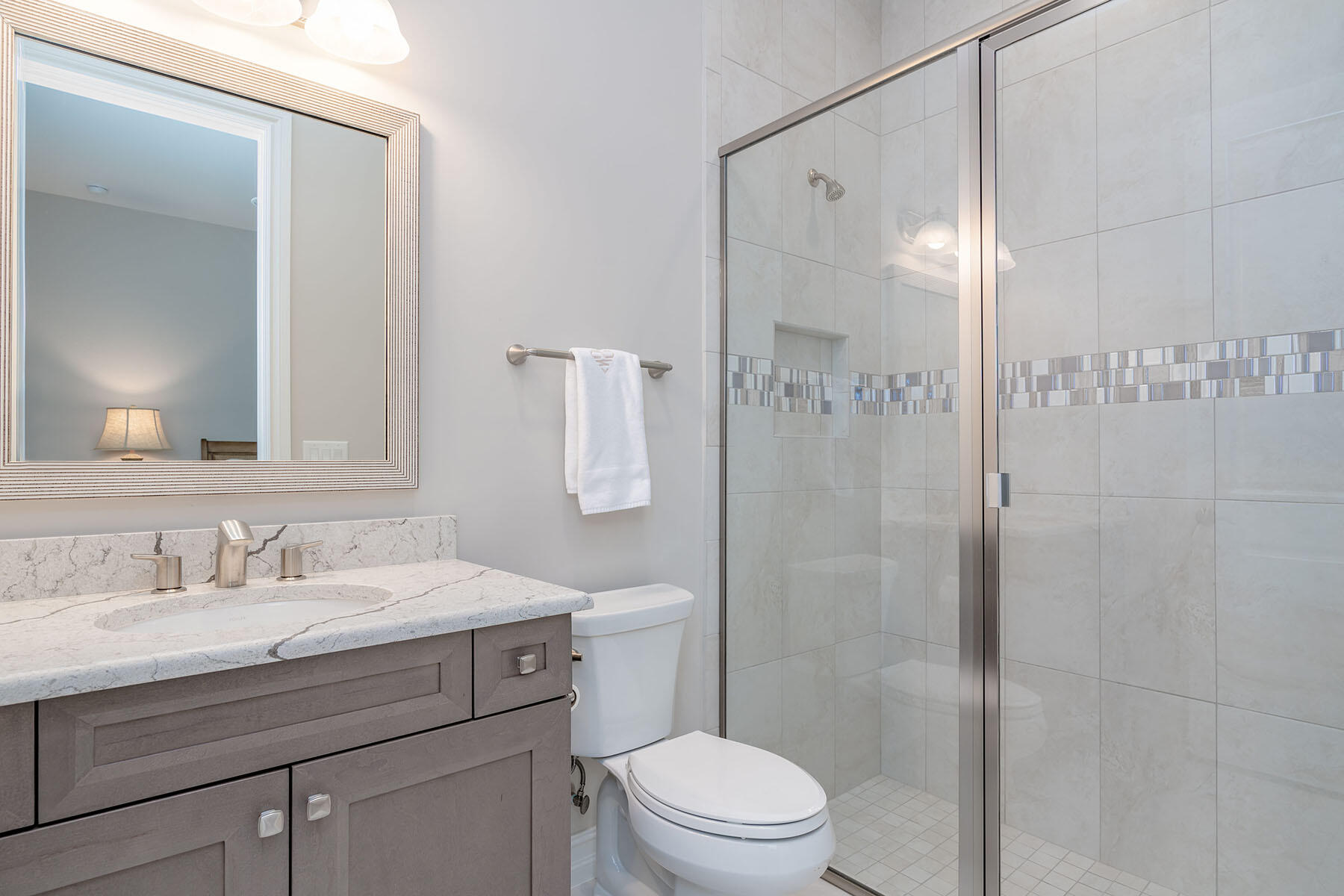 3192 Capistrano Lane Naples, FL 34114 - Photo 15 of 38 a bathroom with a sink a toilet and shower