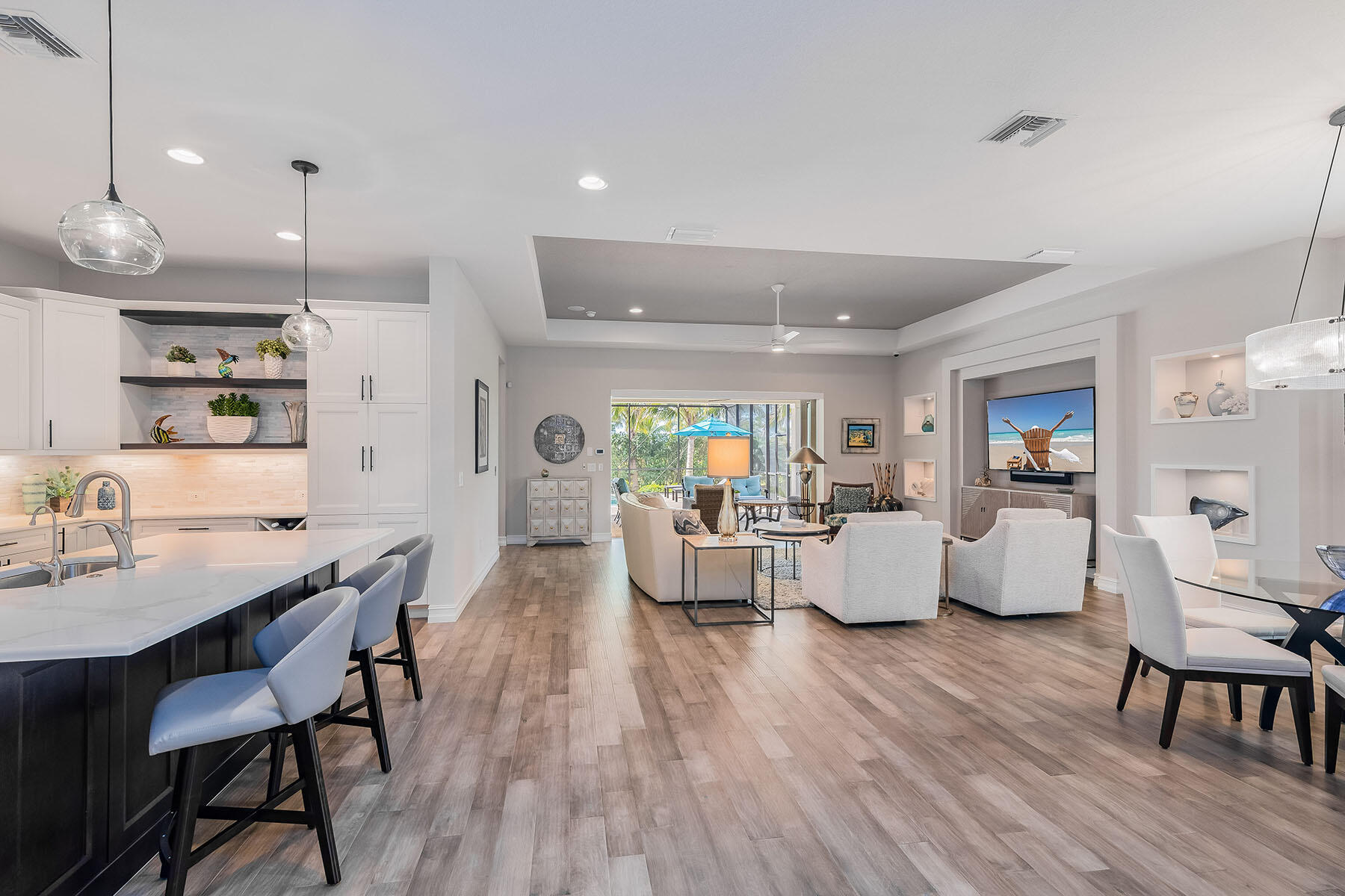 3192 Capistrano Lane Naples, FL 34114 - Photo 3 of 38 a living room with furniture kitchen view and a wooden floor