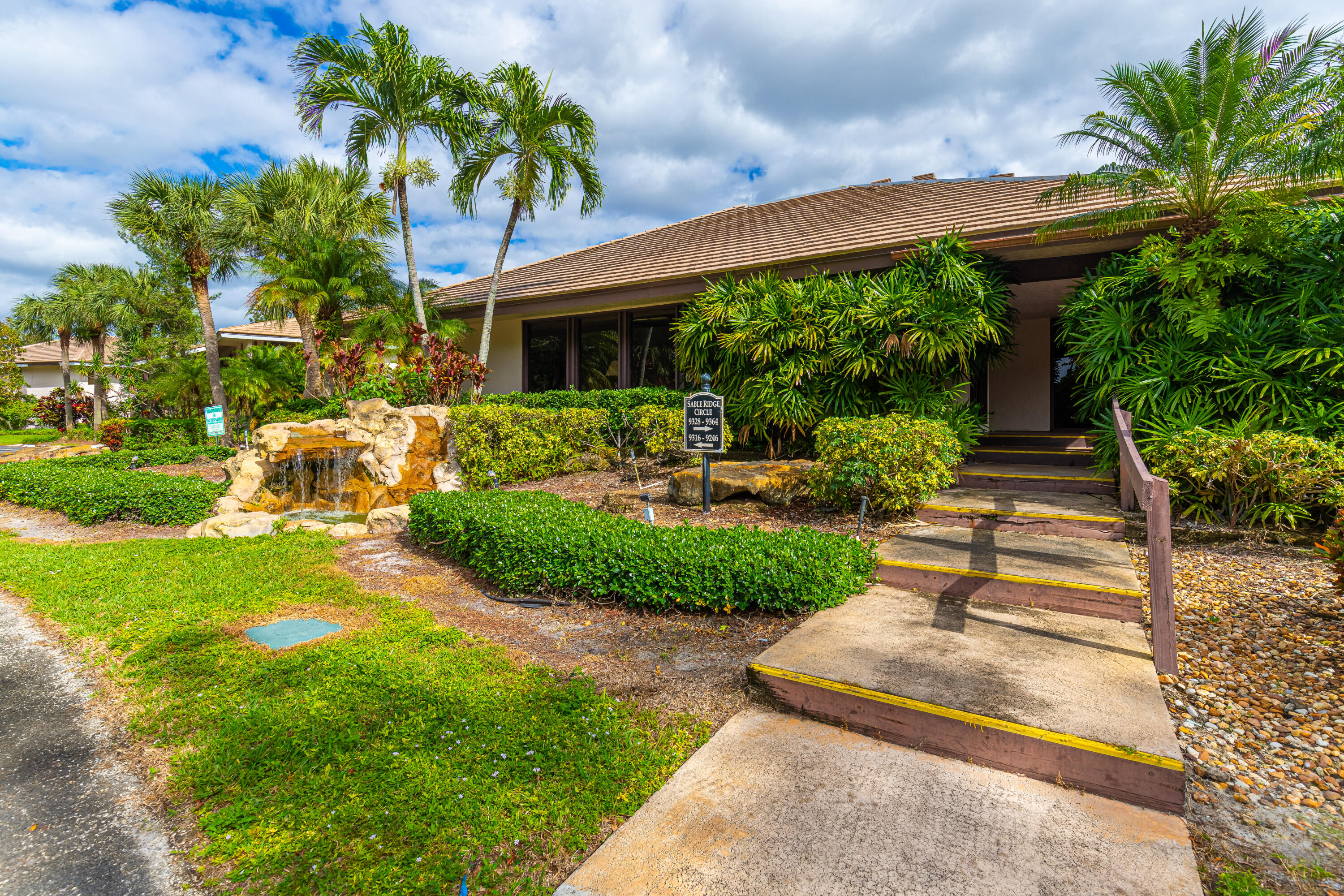 9352 Sable Ridge Circle, Unit B Boca Raton, FL 33428 - Photo 29 of 35 a front view of a house with garden