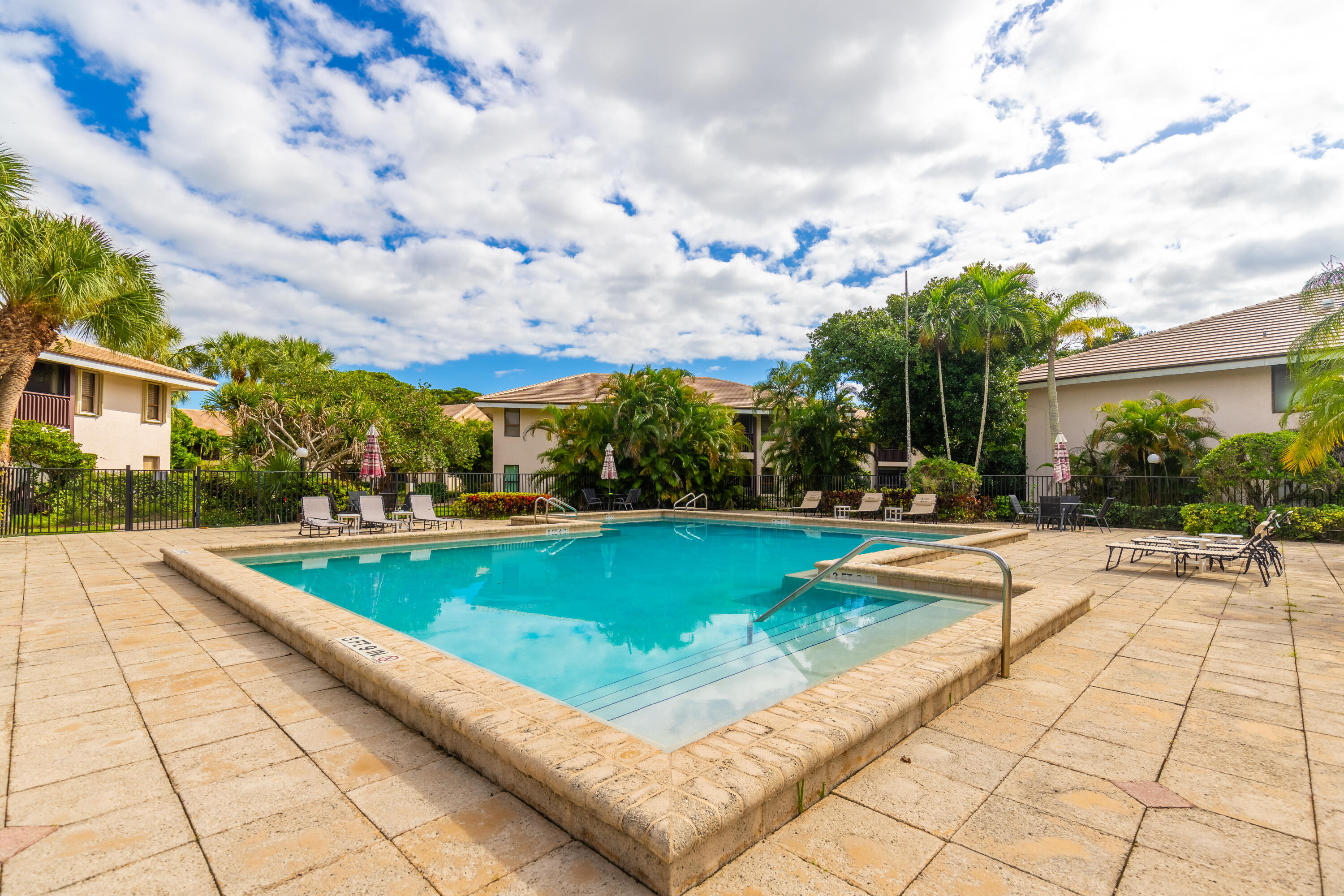 9352 Sable Ridge Circle, Unit B Boca Raton, FL 33428 - Photo 32 of 35 a view of swimming pool with lawn chairs and plants