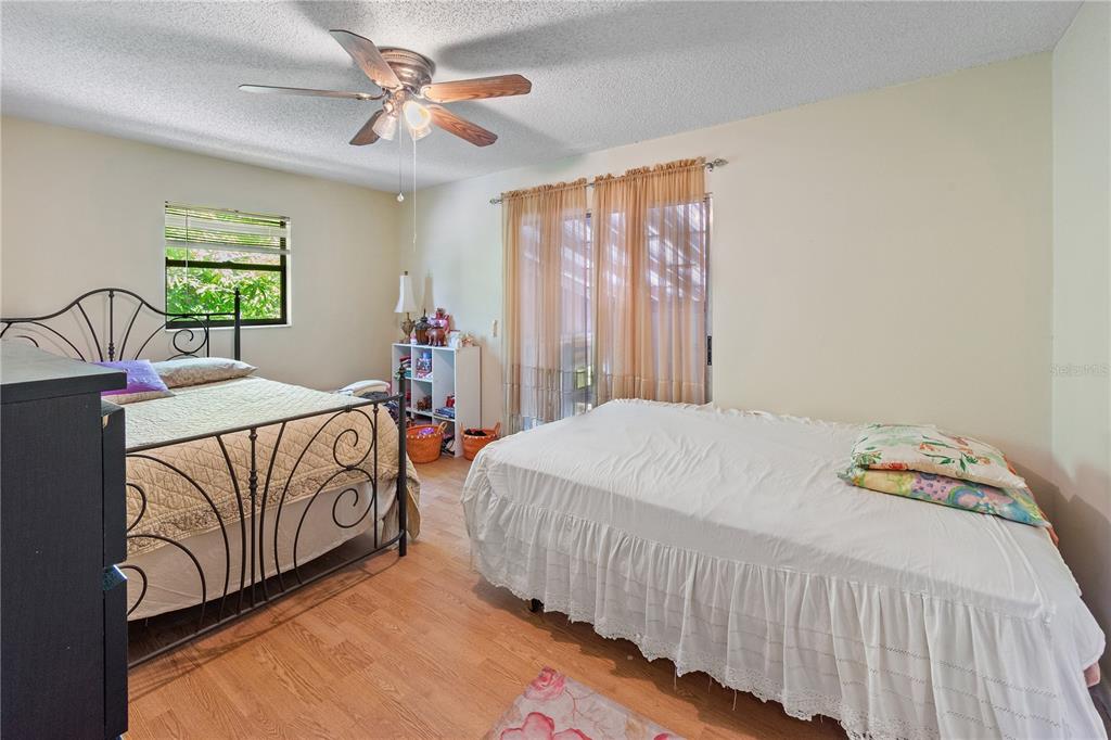 1360 Collany Lane Frostproof, FL 33843 - Photo 12 of 55 a bedroom with a bed and a chandelier