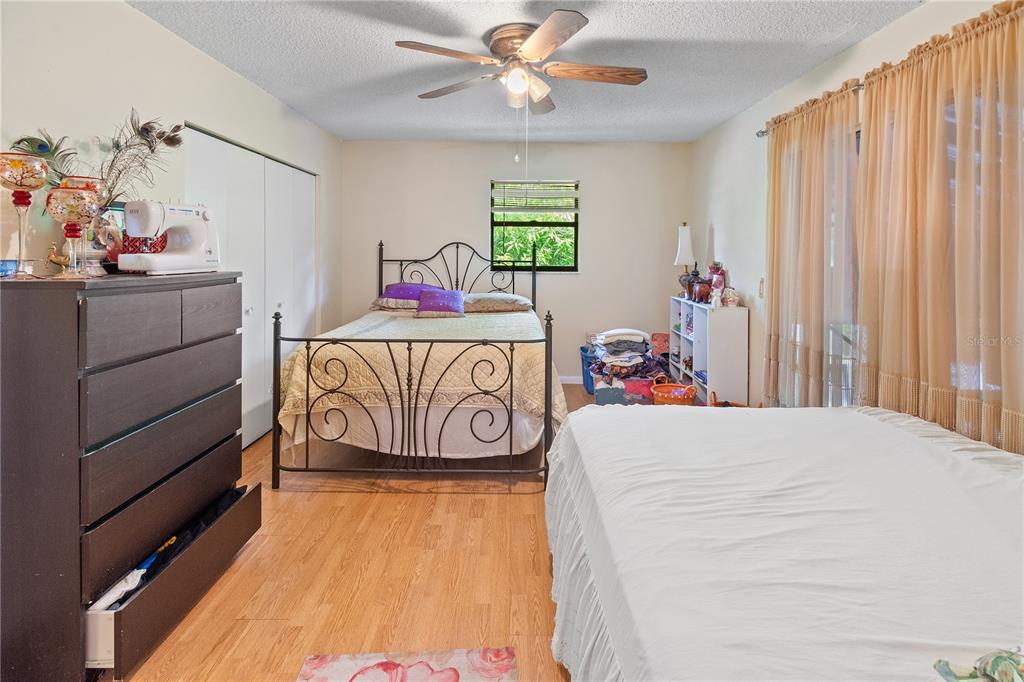 1360 Collany Lane Frostproof, FL 33843 - Photo 13 of 55 a bedroom with a bed and a chandelier