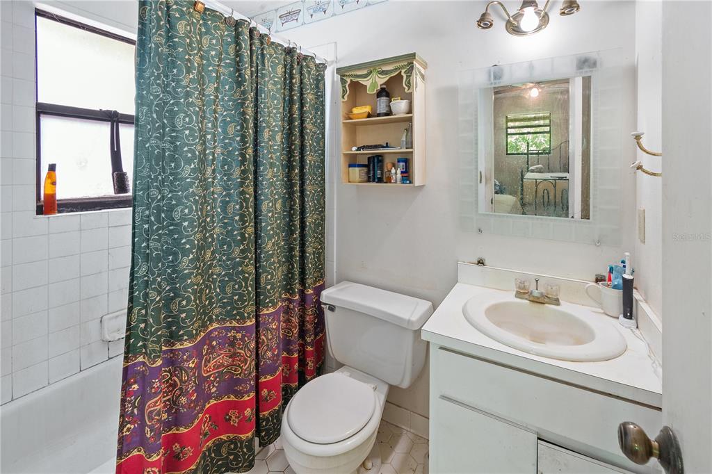 1360 Collany Lane Frostproof, FL 33843 - Photo 14 of 55 a white toilet sitting next to a bathroom sink