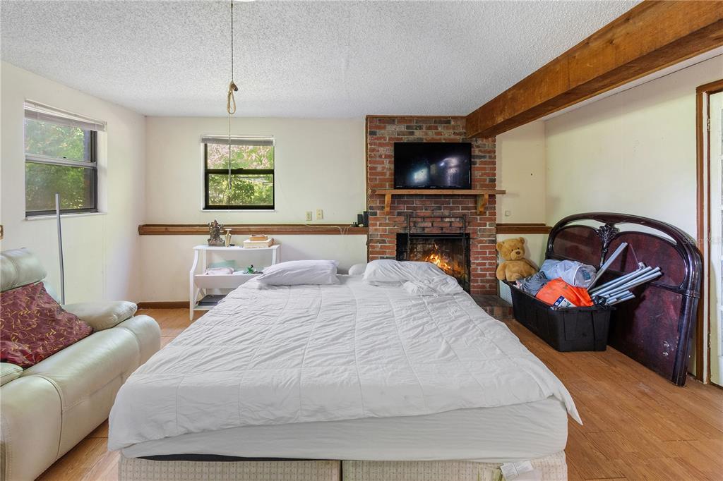 1360 Collany Lane Frostproof, FL 33843 - Photo 16 of 55 a bedroom with a bed and a flat screen tv