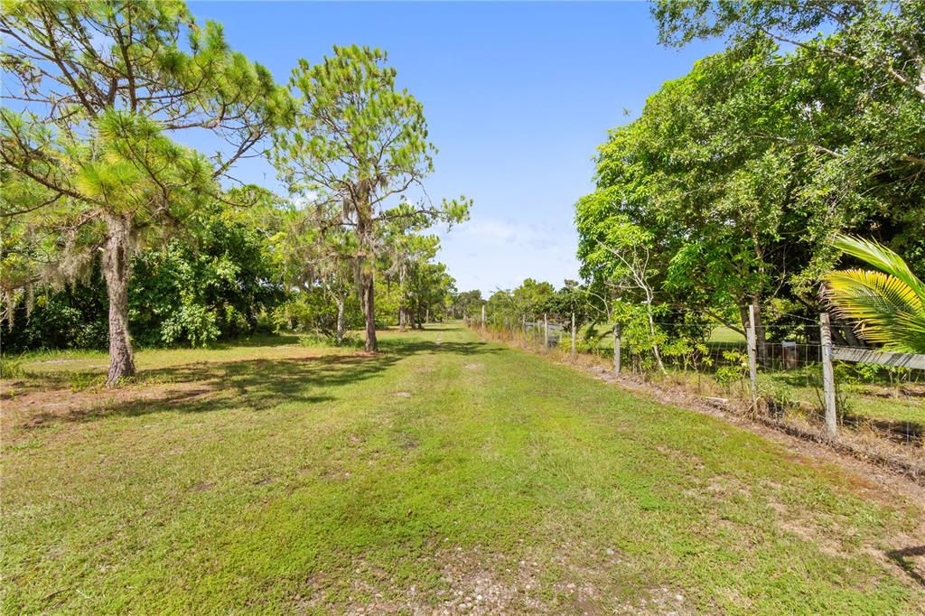 1360 Collany Lane Frostproof, FL 33843 - Photo 25 of 55 a view of a swimming pool with an outdoor space and seating area