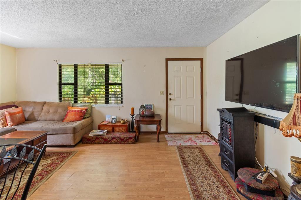 1360 Collany Lane Frostproof, FL 33843 - Photo 4 of 55 a living room with furniture and a flat screen tv