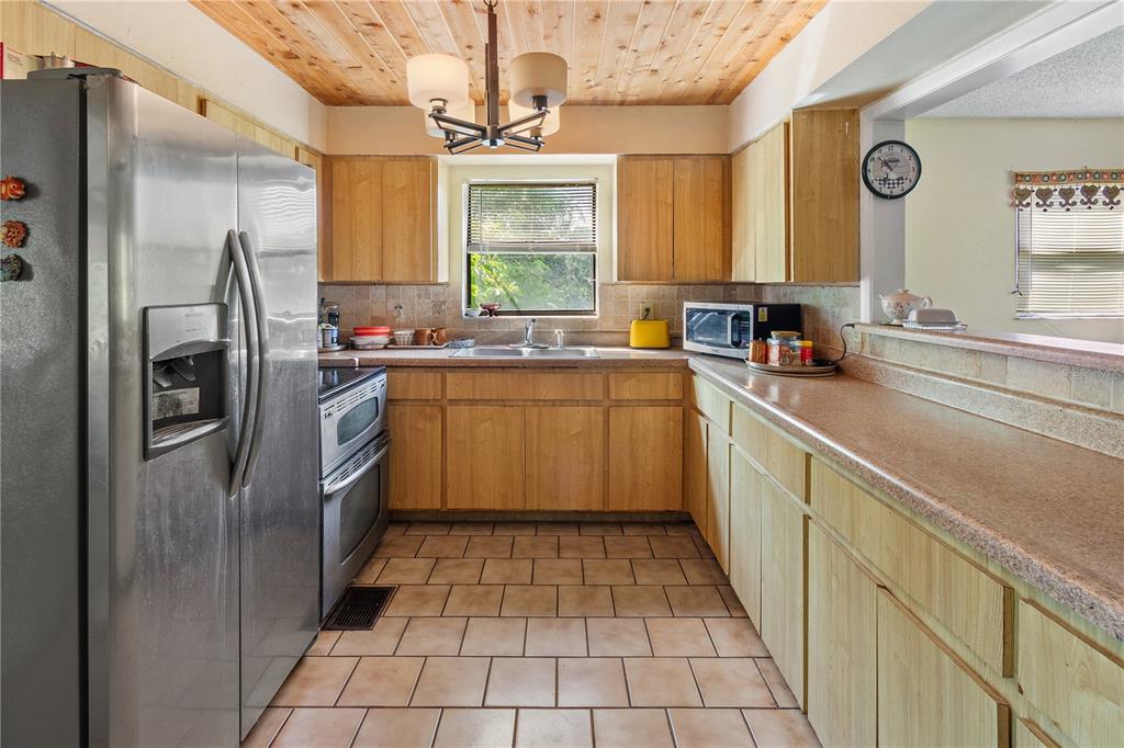 1360 Collany Lane Frostproof, FL 33843 - Photo 6 of 55 a kitchen with a sink a refrigerator and window