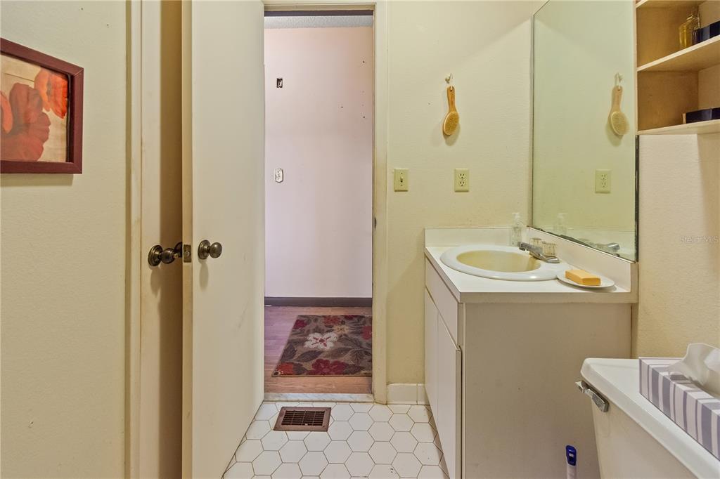 1360 Collany Lane Frostproof, FL 33843 - Photo 9 of 55 a bathroom with a sink and mirror with toilet