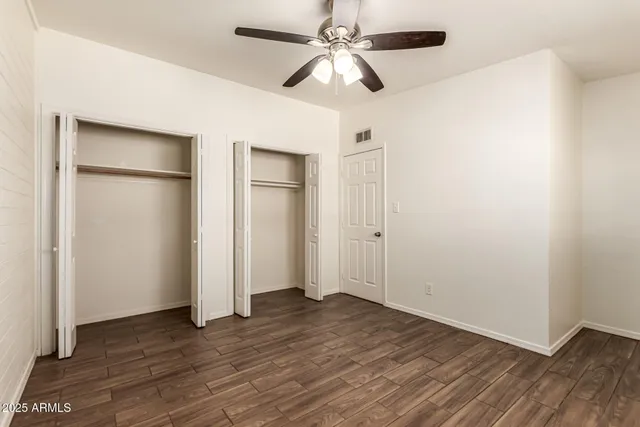 a view of room with hardwood floor and ceiling fan
