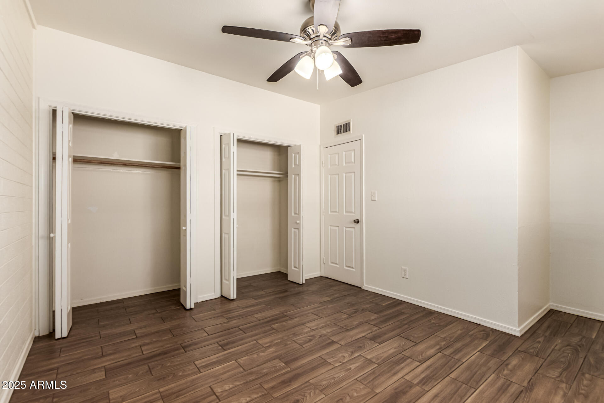 2150 West Missouri Avenue, Unit 108 Phoenix, AZ 85015 - Photo 12 of 28 a view of an empty room with wooden floor