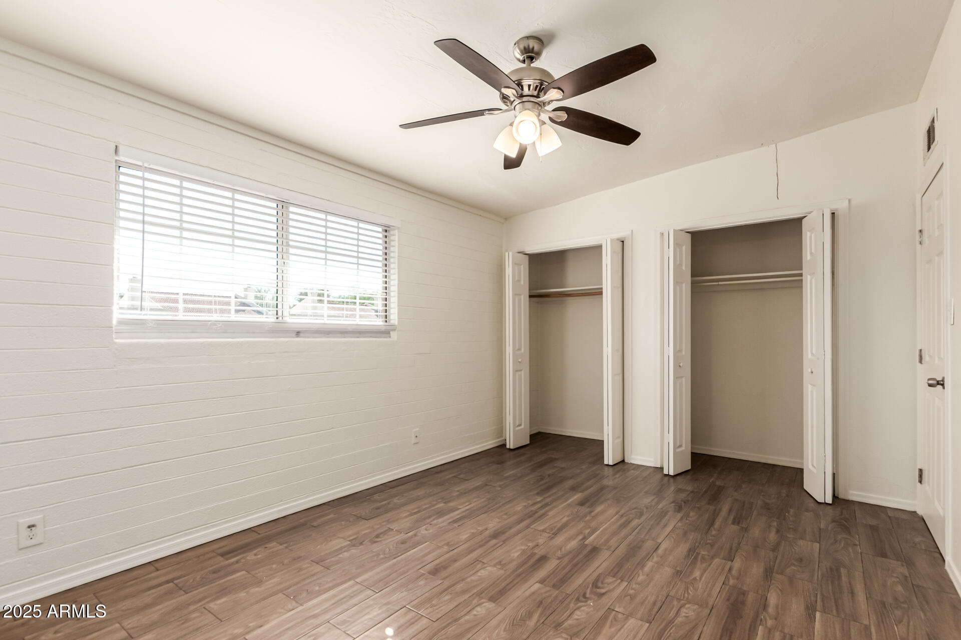 2150 West Missouri Avenue, Unit 108 Phoenix, AZ 85015 - Photo 17 of 28 a view of a big room with wooden floor and windows