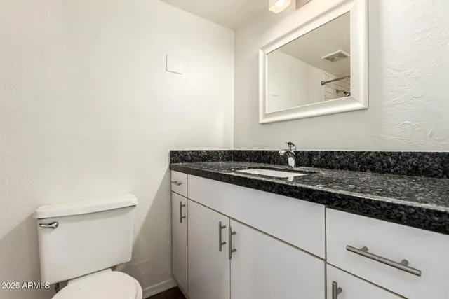 a view of a big room with wooden floor and windows