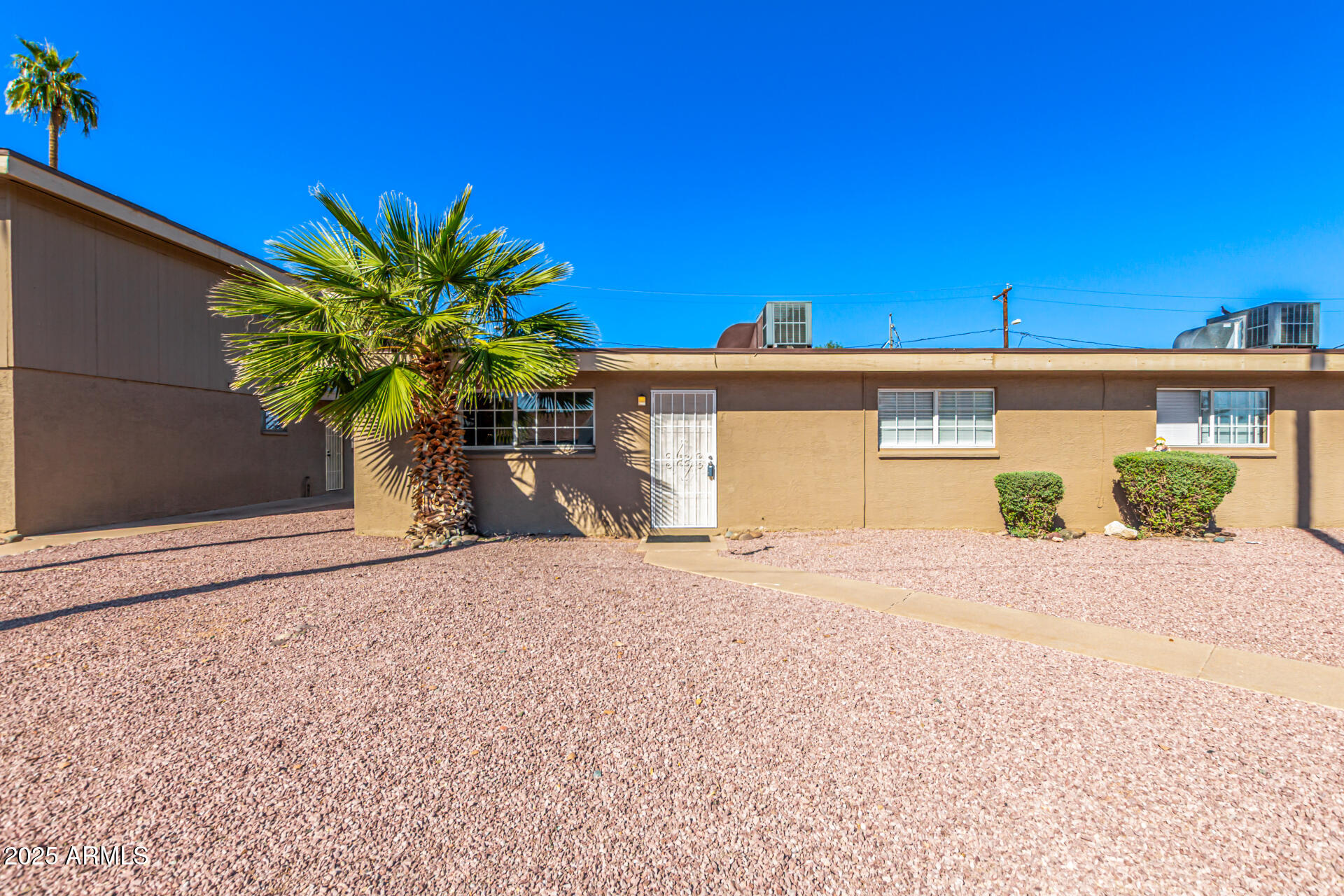 2150 West Missouri Avenue, Unit 108 Phoenix, AZ 85015 - Photo 21 of 28 a front view of a house with a yard