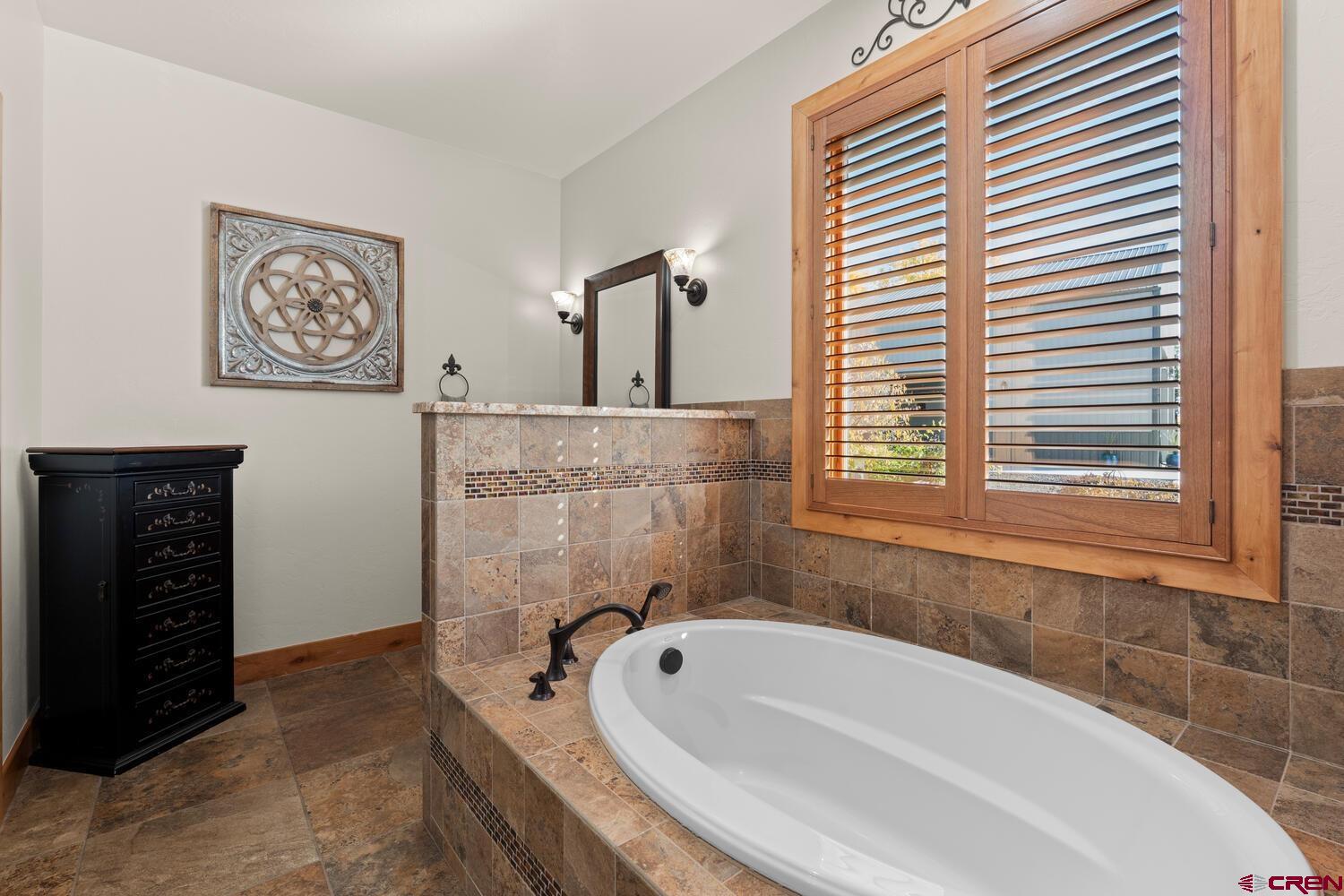 60075-60085 Oak Grove Road Montrose, CO 81403 - Photo 15 of 44 a bathroom with a bathtub and a window