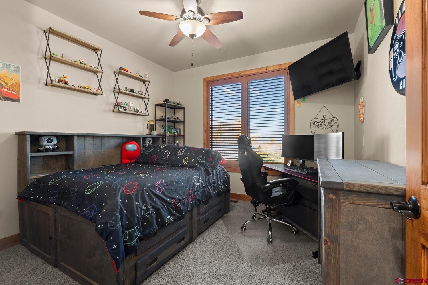 60075-60085 Oak Grove Road Montrose, CO 81403 - Photo 16 of 44 a bedroom with a bed and a flat screen tv