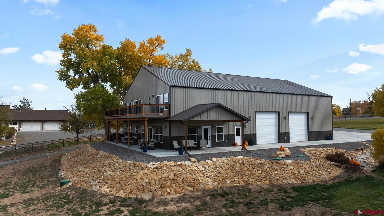 60075-60085 Oak Grove Road Montrose, CO 81403 - Photo 23 of 44 a front view of a house with garden