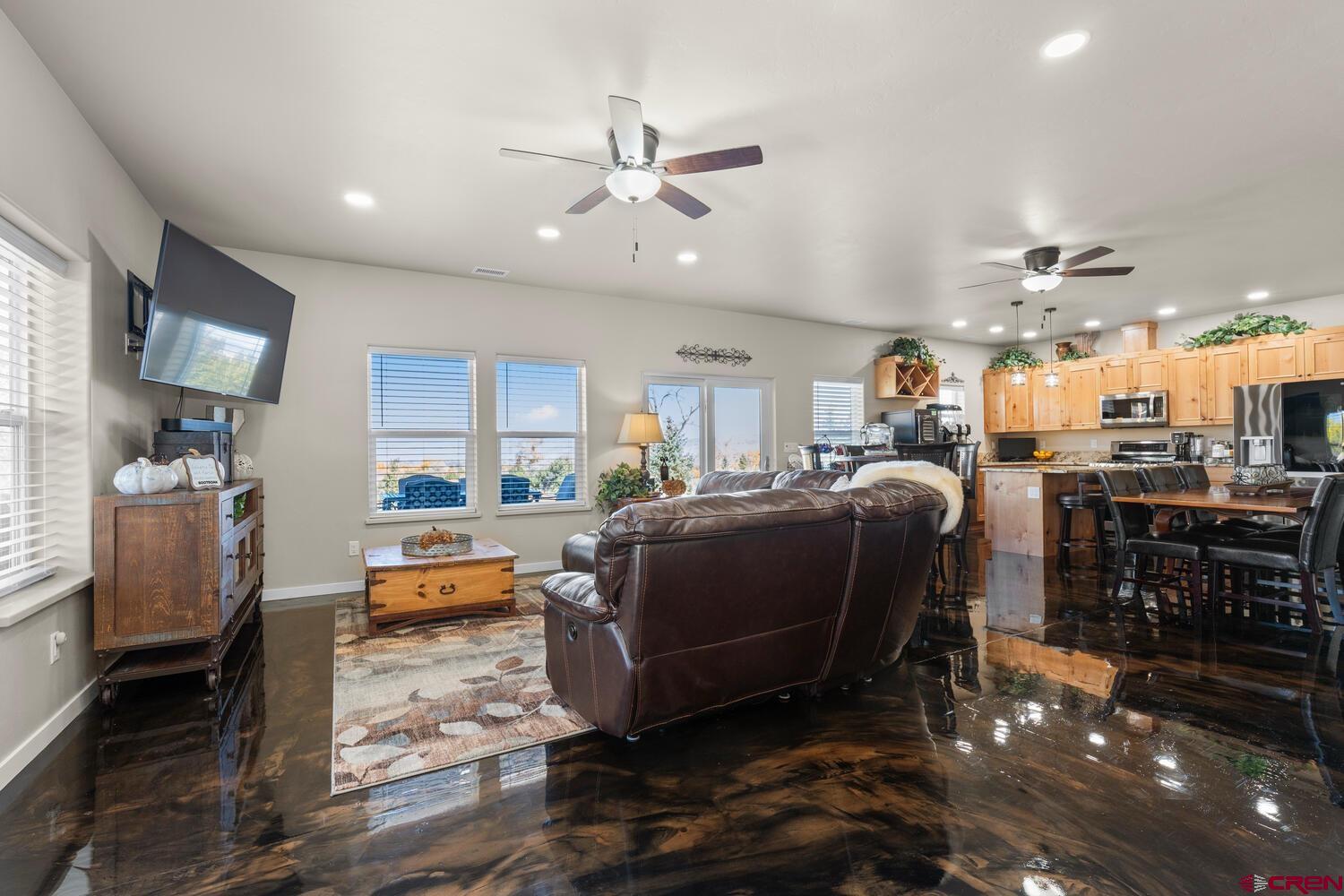 60075-60085 Oak Grove Road Montrose, CO 81403 - Photo 28 of 44 a living room with lots of furniture and kitchen view