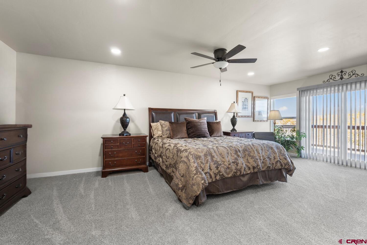 60075-60085 Oak Grove Road Montrose, CO 81403 - Photo 34 of 44 a bedroom with a bed and a ceiling fan