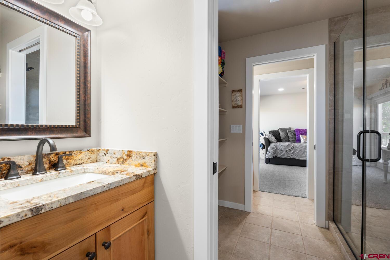 60075-60085 Oak Grove Road Montrose, CO 81403 - Photo 36 of 44 a en suite bathroom with a sink and a mirror