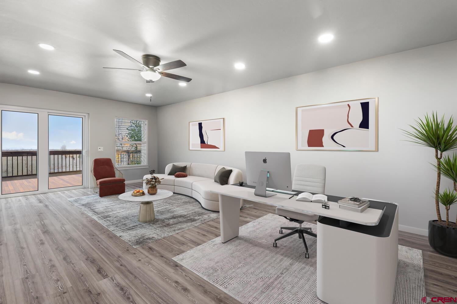 60075-60085 Oak Grove Road Montrose, CO 81403 - Photo 37 of 44 a living room with furniture a flat screen tv and a potted plant