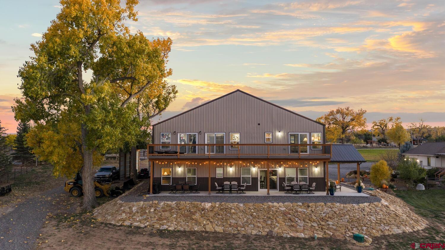 60075-60085 Oak Grove Road Montrose, CO 81403 - Photo 6 of 44 a front view of a house with a yard