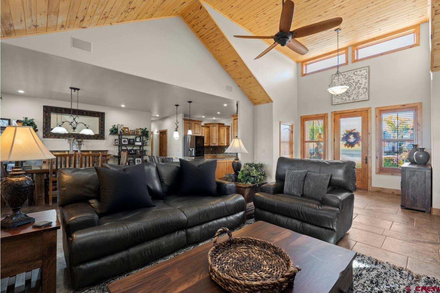 60075-60085 Oak Grove Road Montrose, CO 81403 - Photo 9 of 44 a living room with furniture a rug and a fireplace