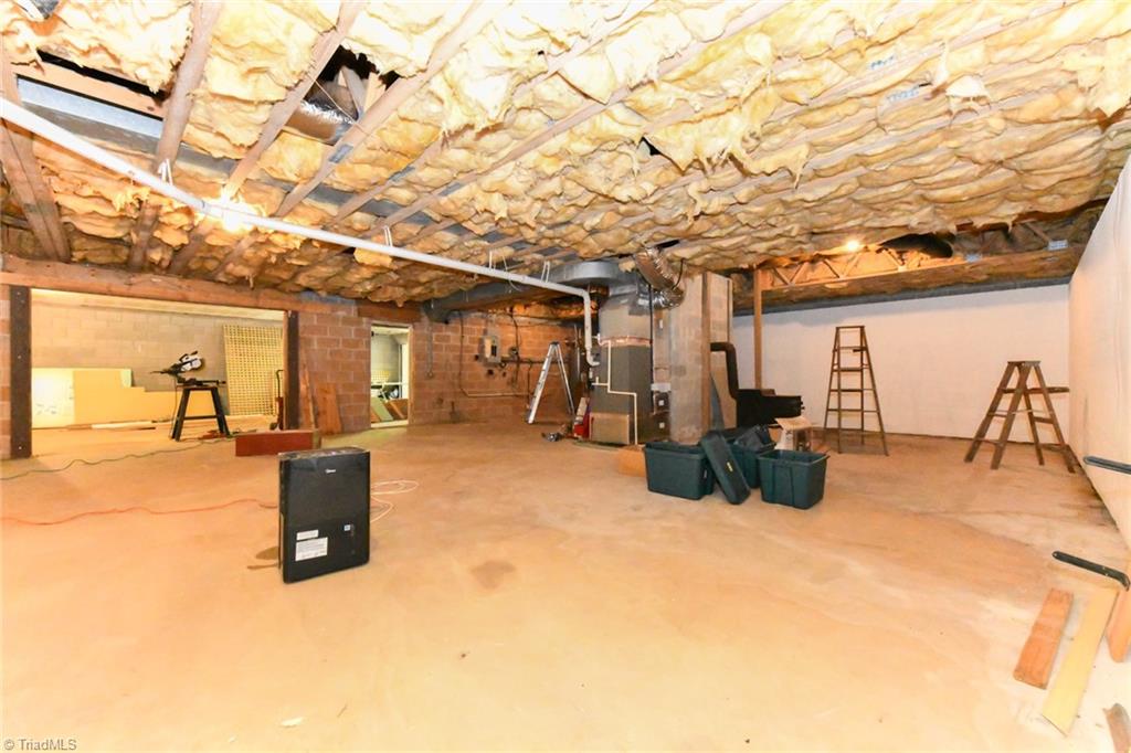 8202 Dennis Road Walnut Cove, NC 27052 - Photo 29 of 35 Basement With Wood Stove