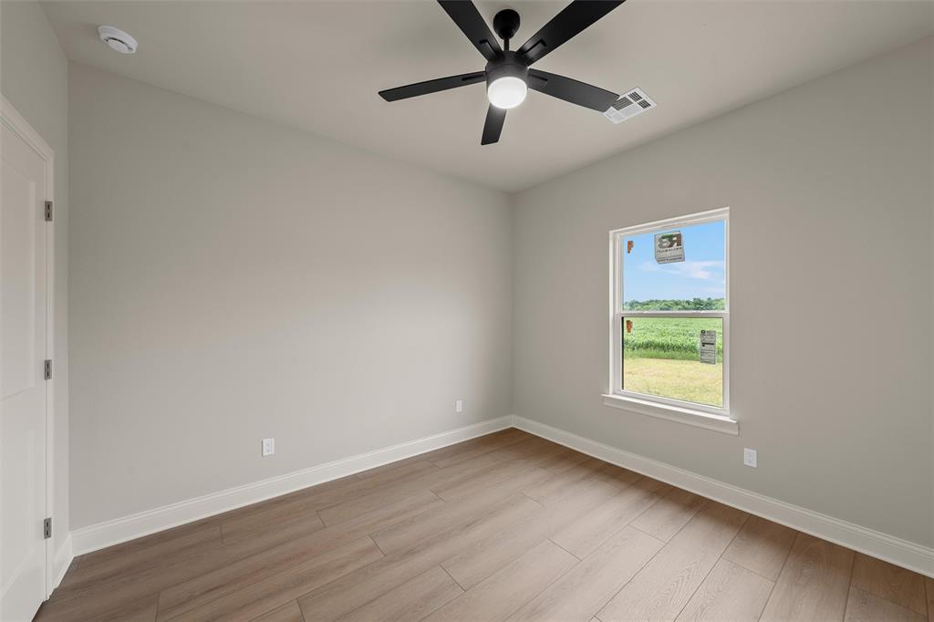 5200 Bogey Lane Waco, TX 76708 - Photo 20 of 37 an empty room with a window and a fan