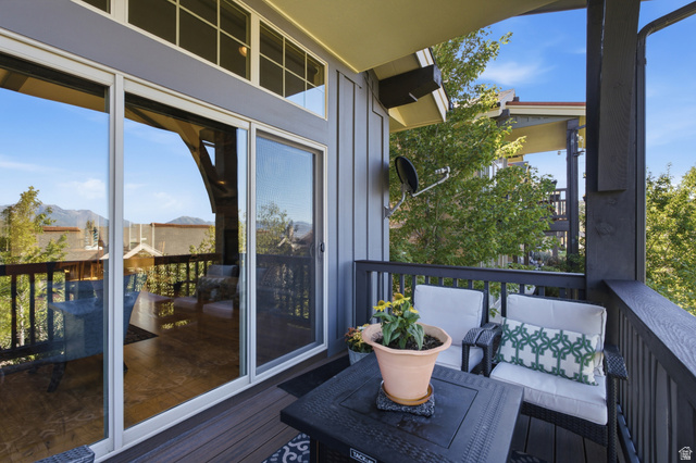 5207 North Oldgate Road Heber City, UT 84032 - Photo 8 of 58 Outdoor balcony with dark composite decking, a dark railing, and sliding glass doors