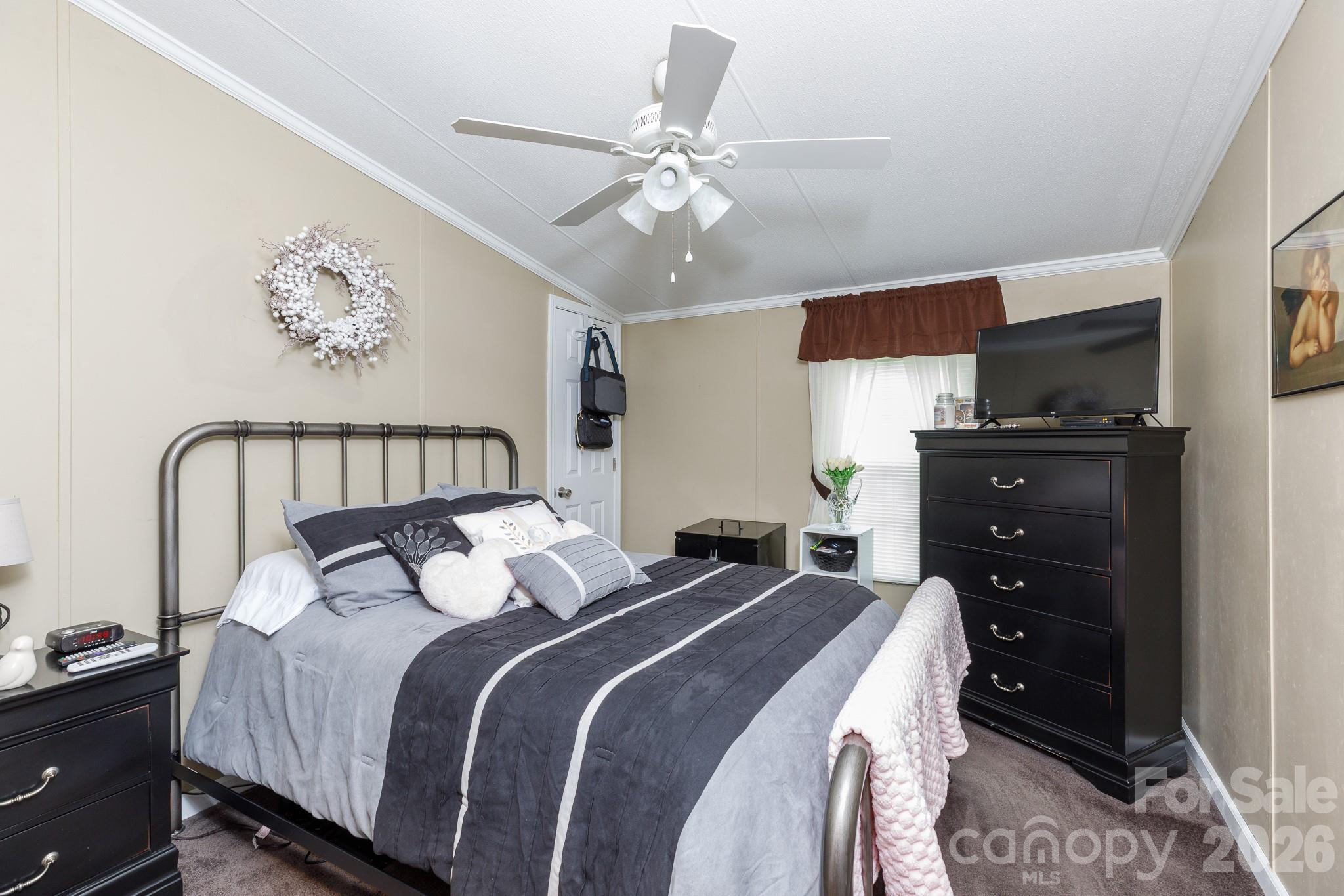 652 Sutton Spring Road York, SC 29745 - Photo 14 of 28 a bedroom with a bed and a chandelier