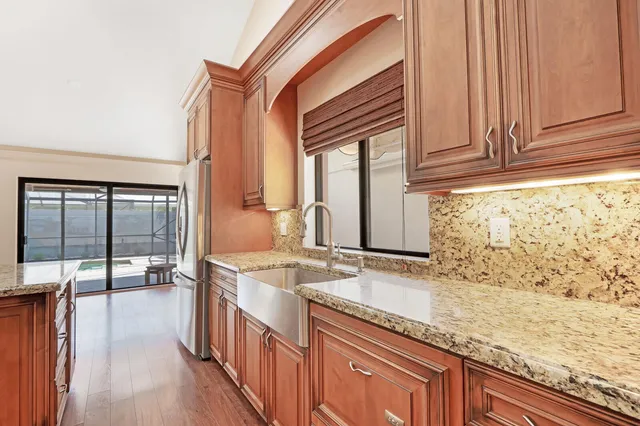 a bathroom with granite countertop a sink and a window