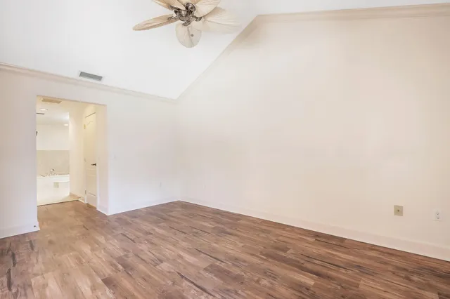 a view of a room with wooden floor