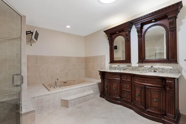 a bathroom with a tub sink and mirror